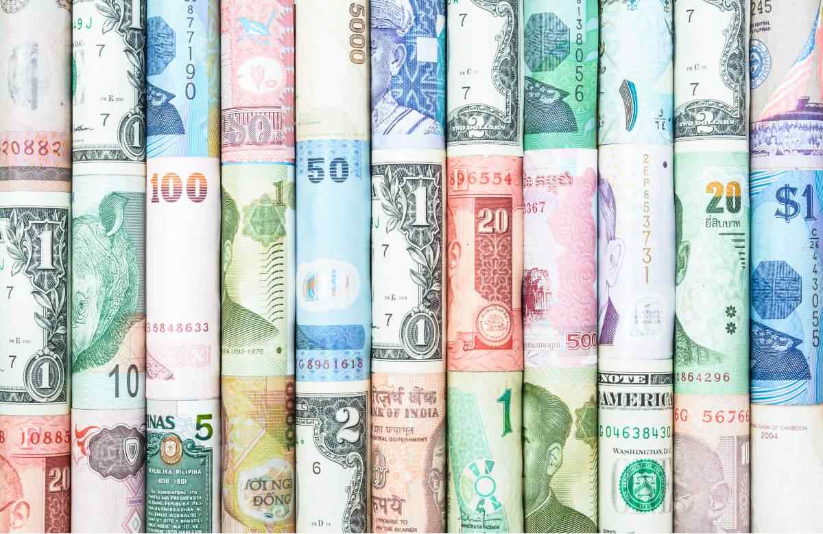 Different currencies rolled next to each other 
