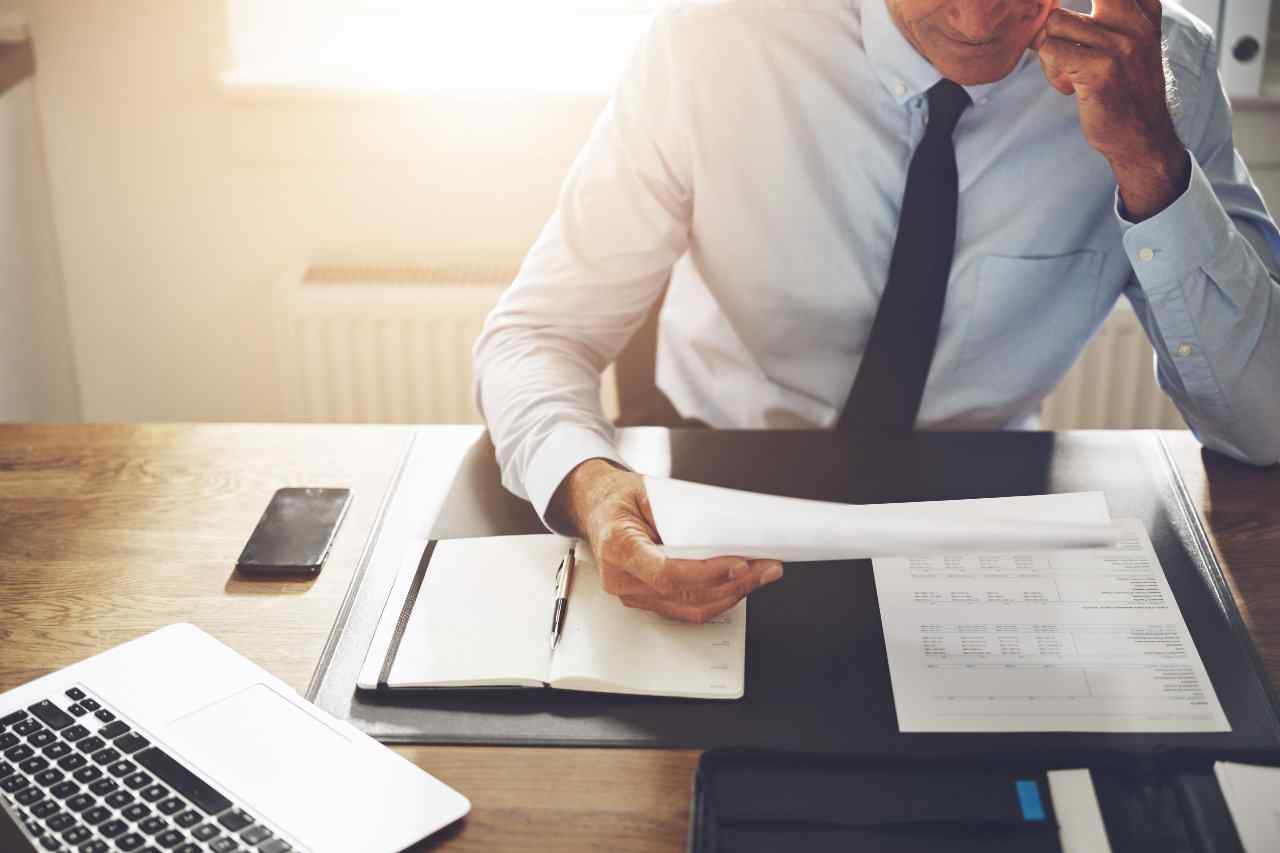 Professional looking over 401k paperwork.