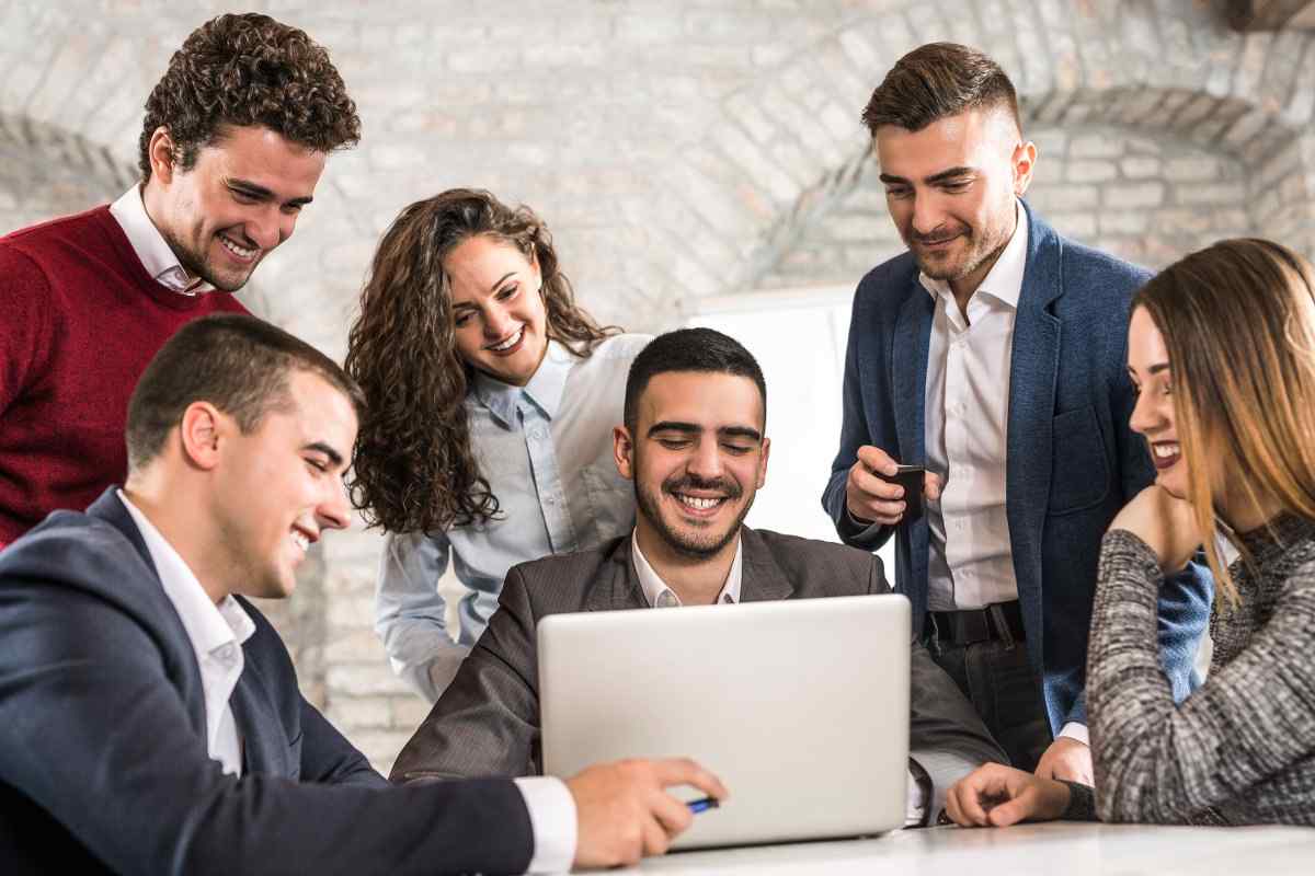 Group of employees laughing at work.