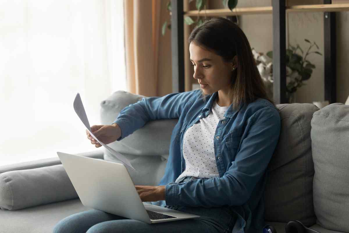 Young adult comparing loans on laptop.