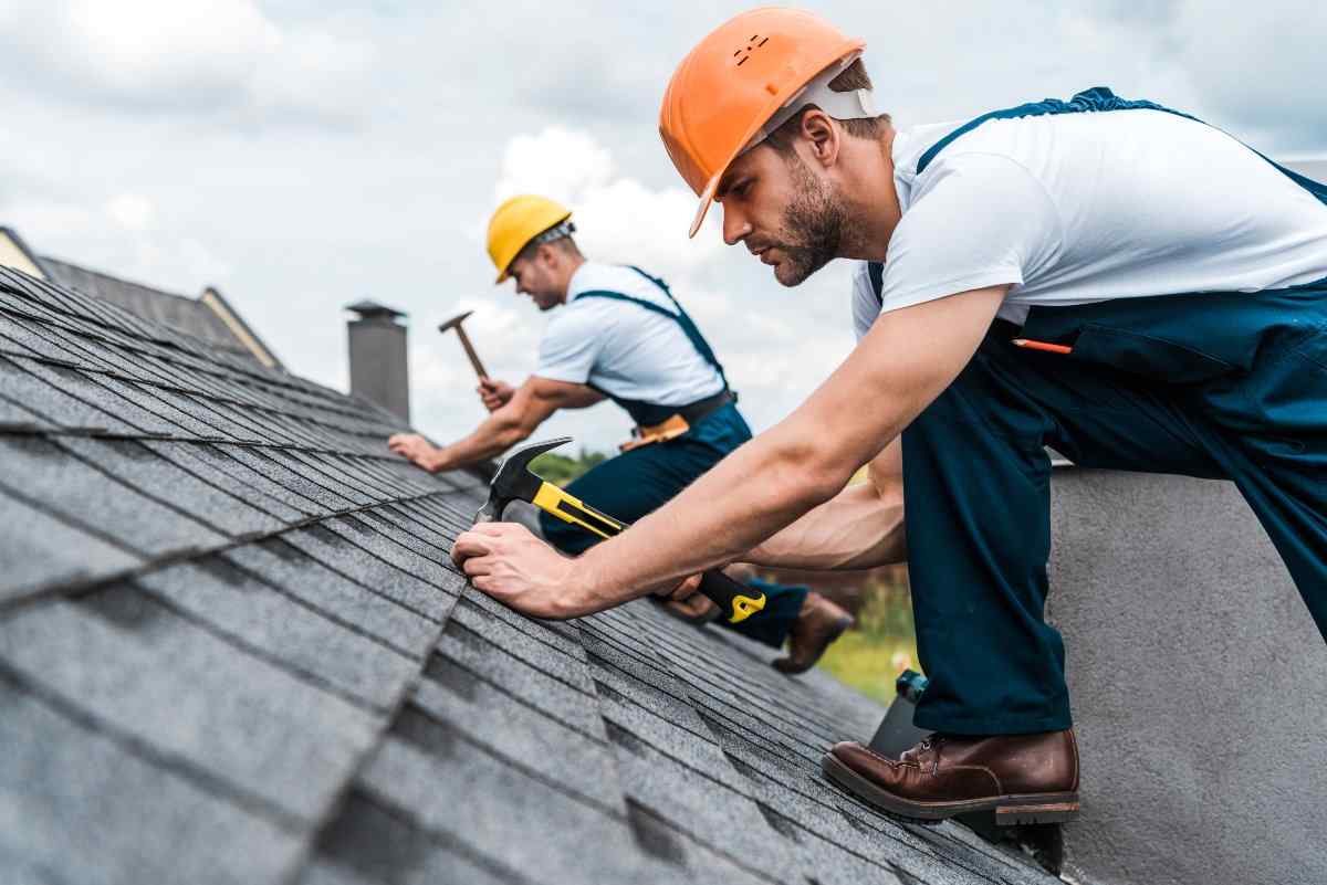 Construction worker repairing roof