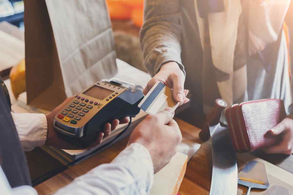 Shopper handing credit card to cashier