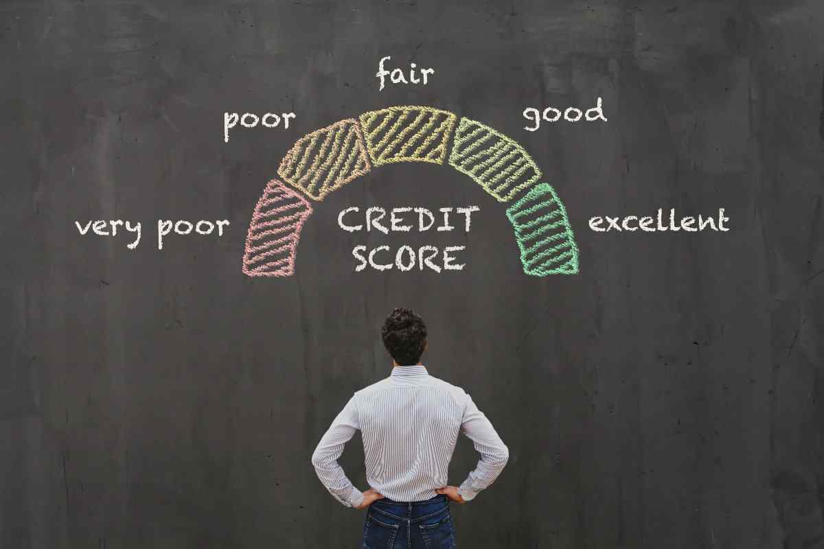 Individual with back turned looking at graphic of credit score scale 