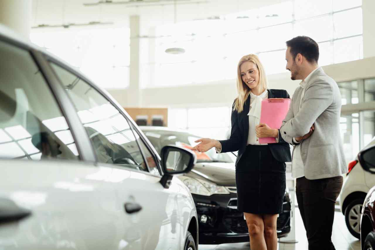 Individual meeting with car salesperson at dealership