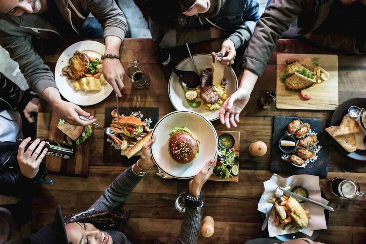 Group of young adults dining out at restaurant 