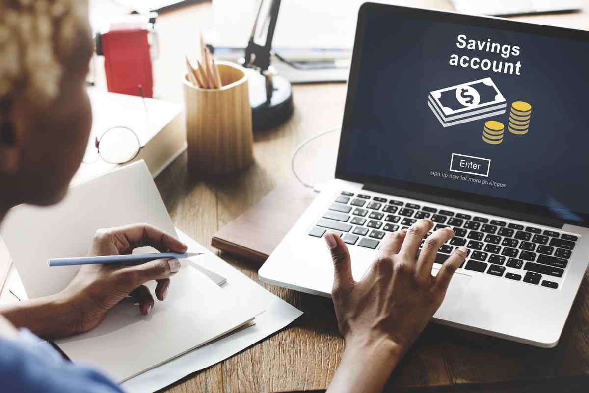 Woman on a laptop looking up a savings account.