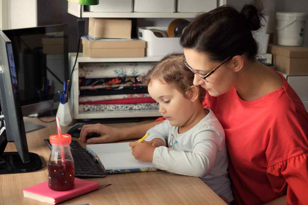 A mother and her young daughter working on an emergency savings plan.