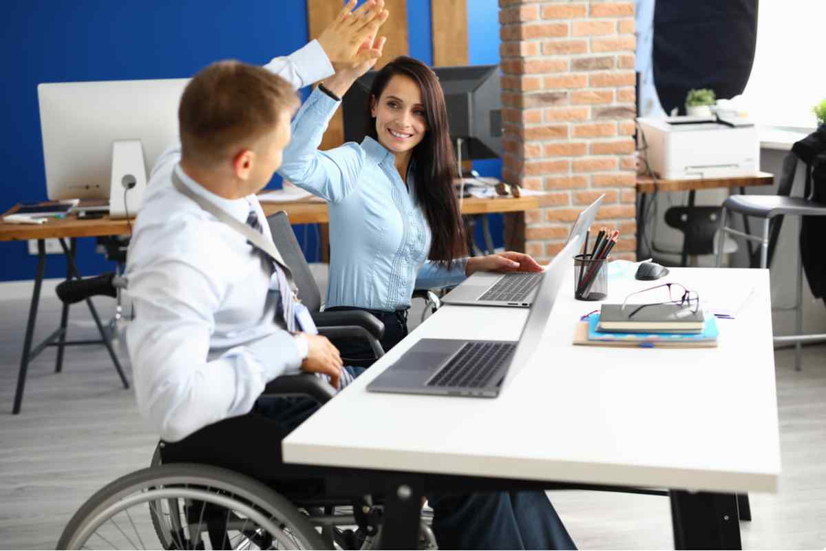 Man and woman sitting at a computer lab.