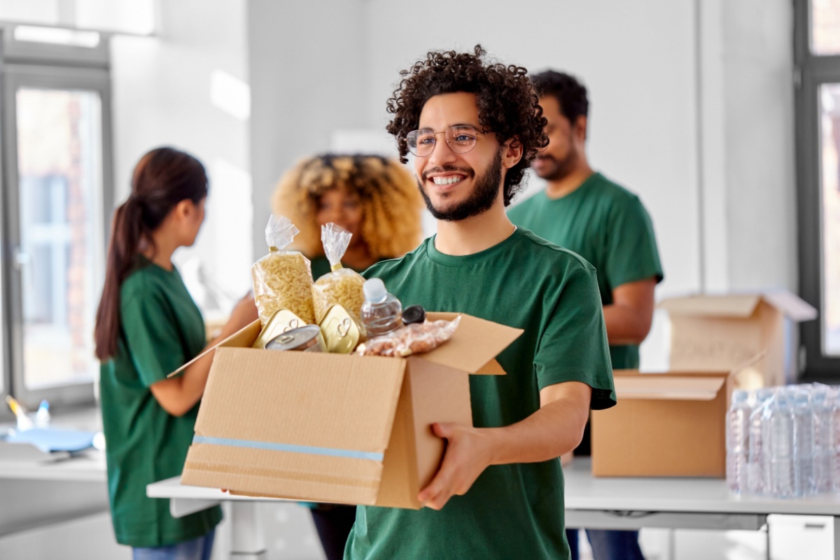 Nonprofit volunteer holding box of food