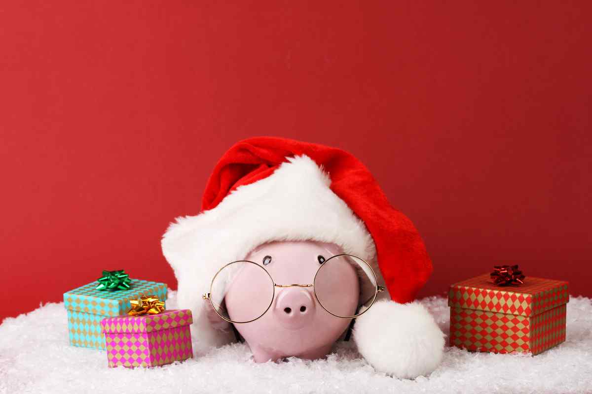 Piggy bank with holiday presents around it.