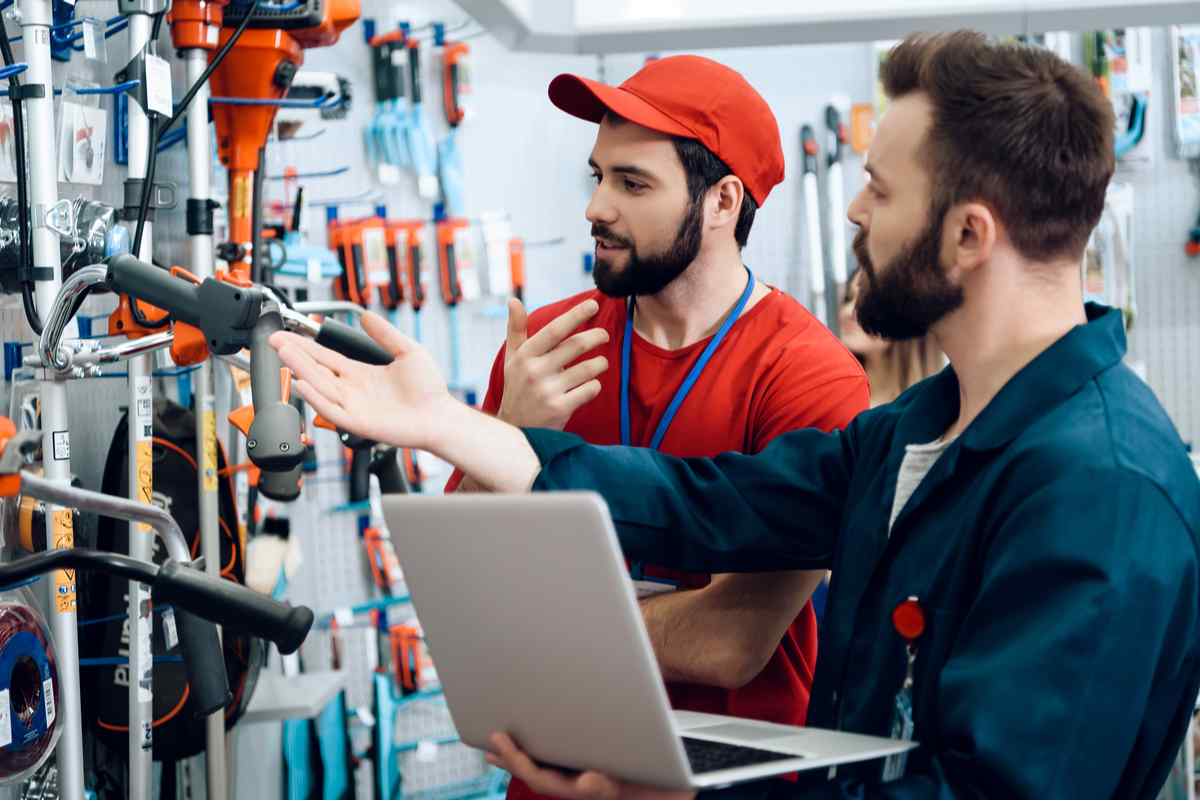 Two men talking to each other at a store.