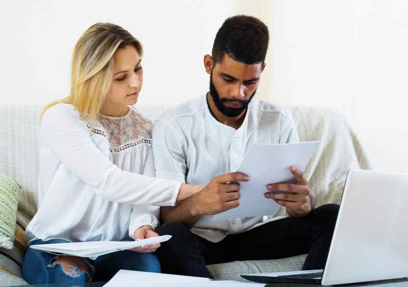 Man and woman looking into opening a joint bank account.