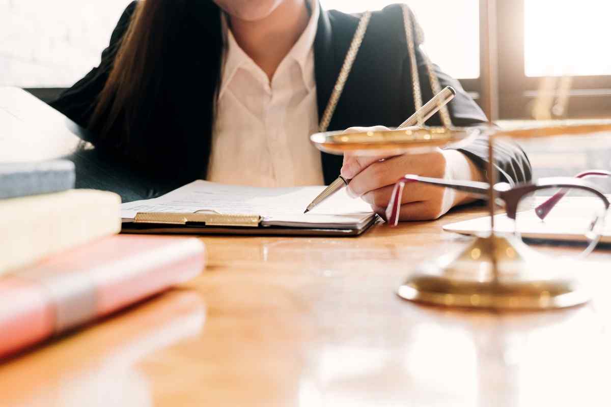 Lawyer in office signing paperwork.