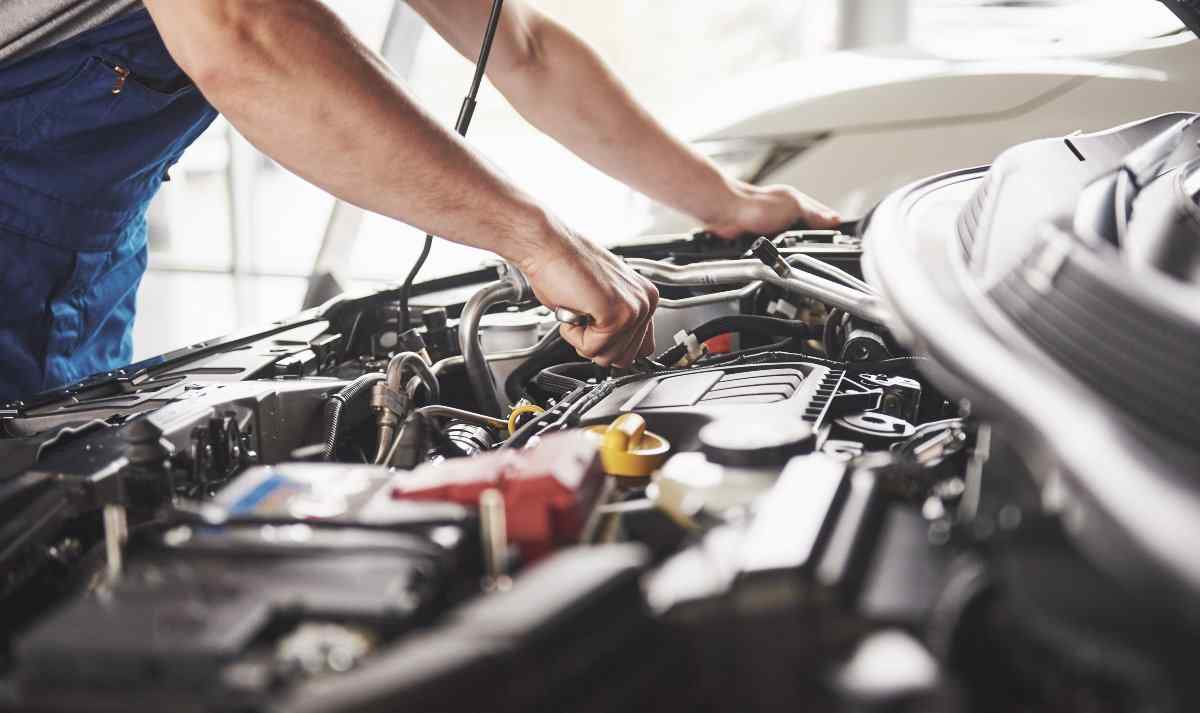 Close up on mechanic working on the car's engine