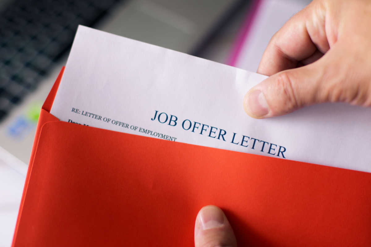 Close up on individual opening job offer letter 