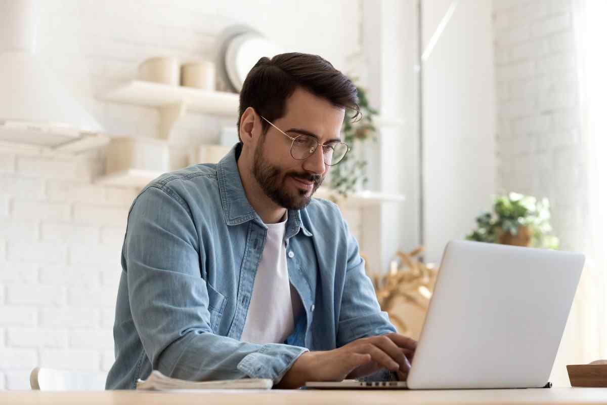 Individual working on laptop.