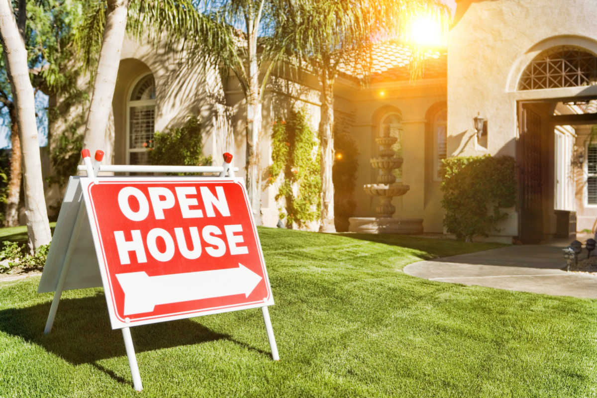 House with open house sign on lawn