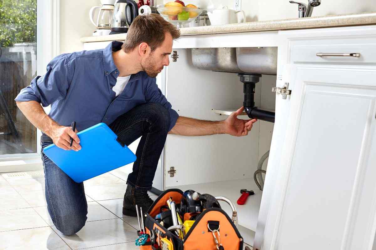 Plumber fixing sink.