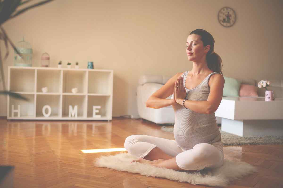 Pregnant woman doing yoga at home.