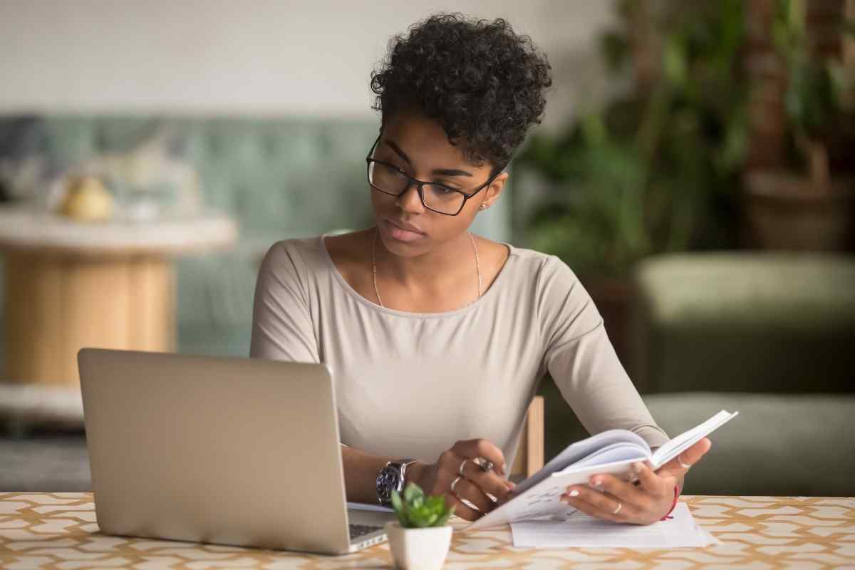 Young adult researching on laptop