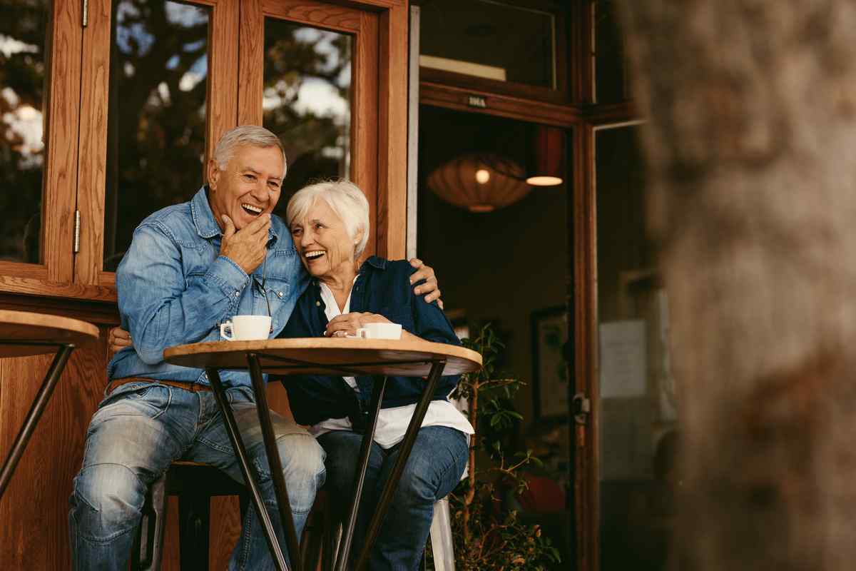 Retirees smiling and enjoying each other.