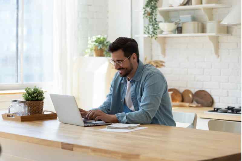 Man using his laptop in his home.