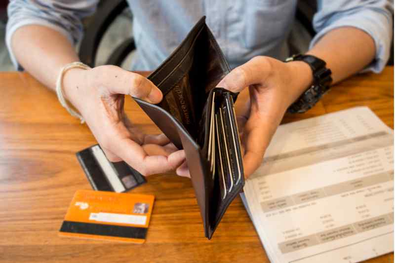 Man looking through wallet.