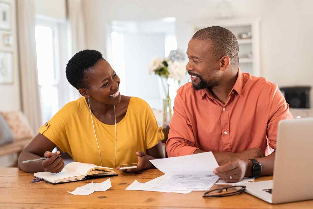 Smiling couple managing expenses.