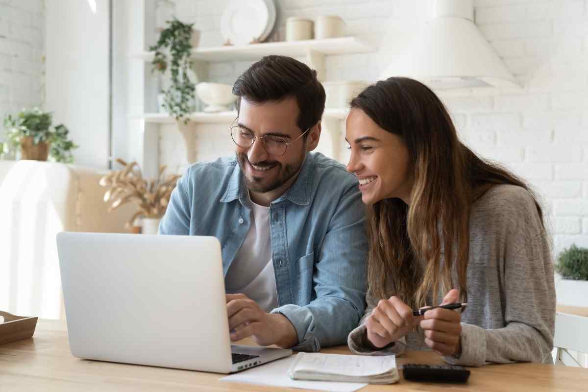 Smiling couple in front of laptop.