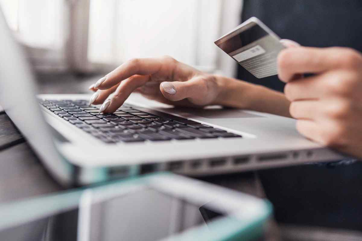 Woman holding a credit card.