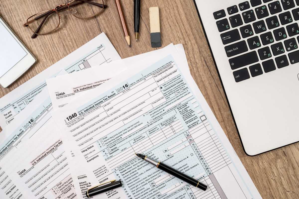 Overhead view of laptop and tax forms