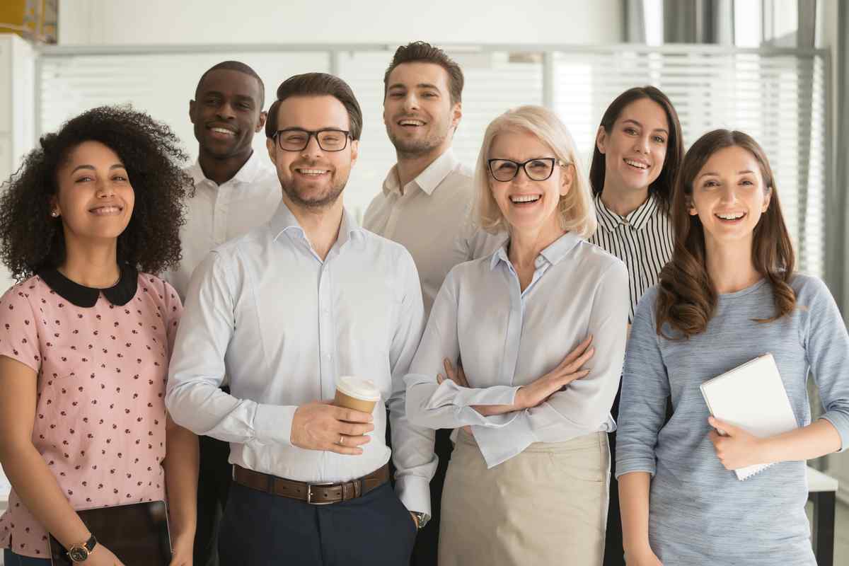 Group of employees standing in an office.