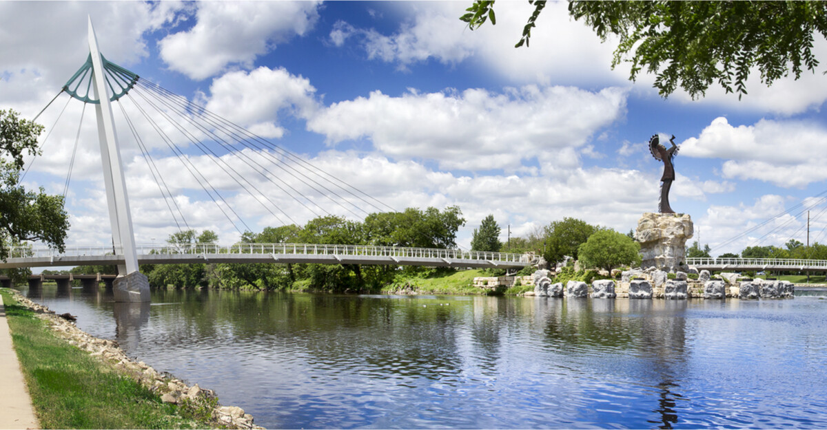 View of lake, bridge, and statue in Kansas.