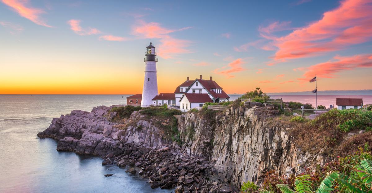 Landscape view of ocean and lighthouse in Maine.