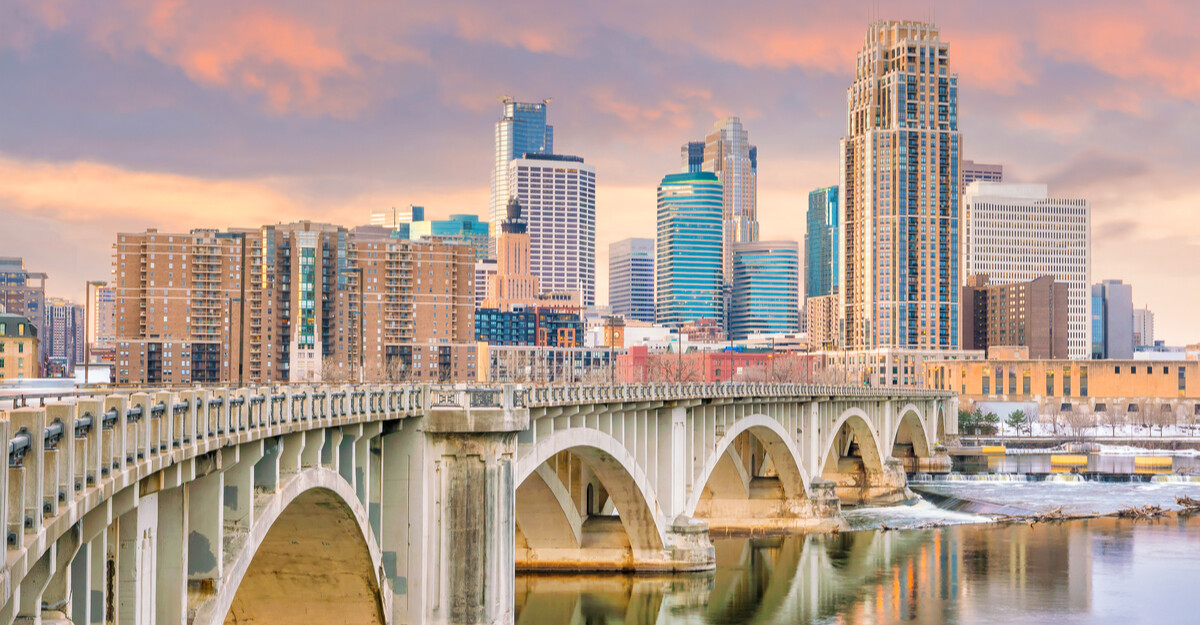 View of bridge, lake, and downtown buildings in Minneapolis, Minnesota.