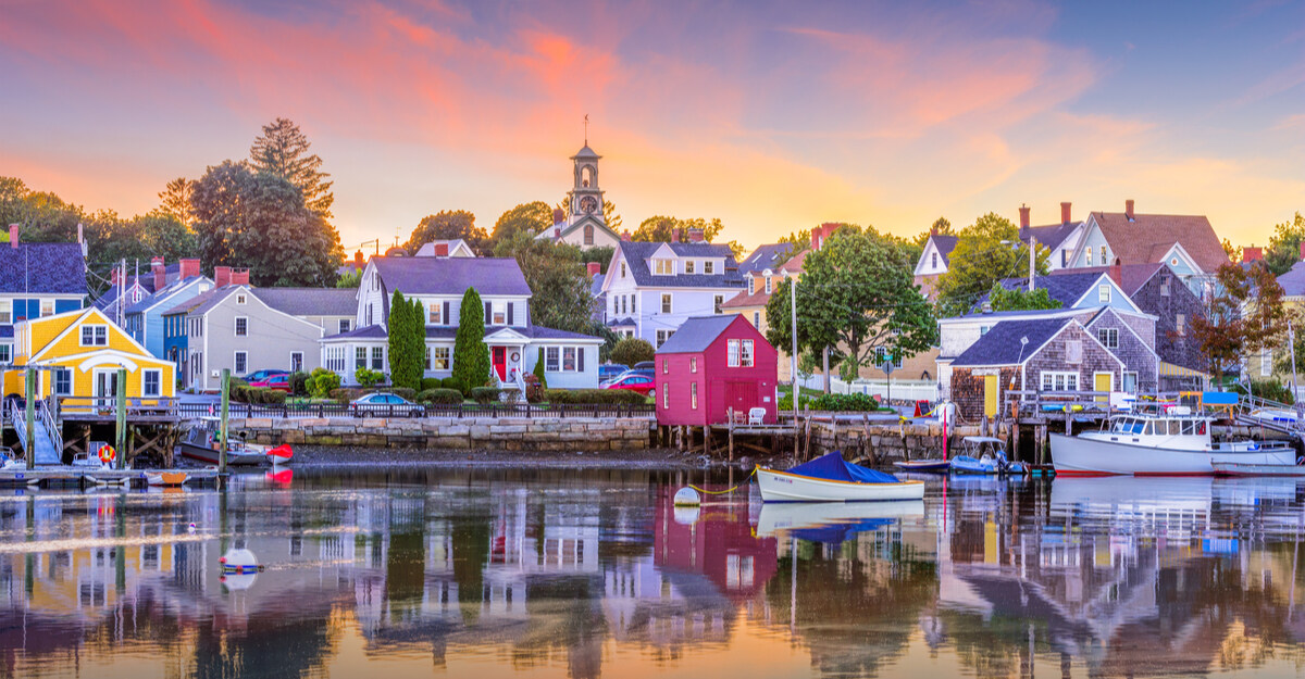Landscape photo of beach houses, lake, and boats in New Hampshire.