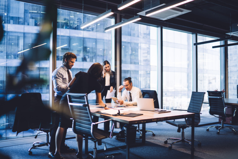 Business colleagues going over a report at a conference table.