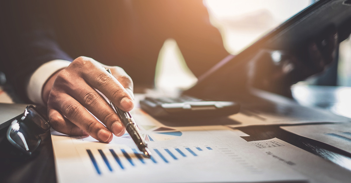 Man looking at a bar graph showing his bank account gains.